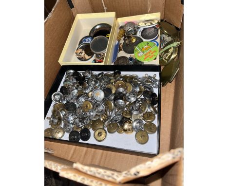 A box of vintage badges and military buttons. 