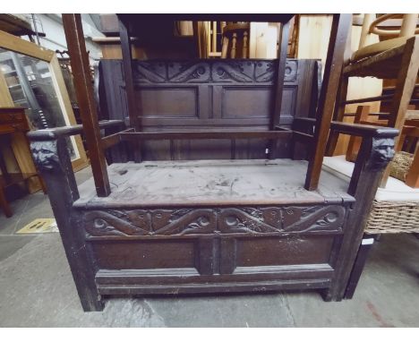 A carved oak monk's bench, width 106.5cm. 