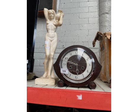 A 1930s oak cased mantel clock (glass cracked) and a composite figure of a nude lady. 