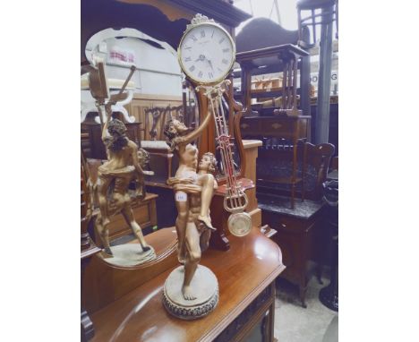 A figural clock modelled as a nude couple. 