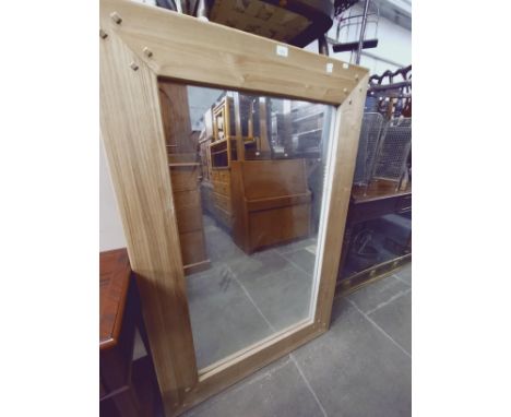 A large oak framed mirror and a large print, interior scene. 