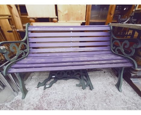 A cast metal garden bench and a pair of bench ends. 