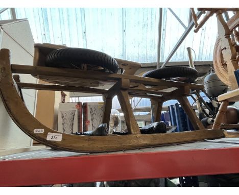 A Prince Lionheart wooden children's bike, a pair of ice skates &amp; a vintage wooden sledge 