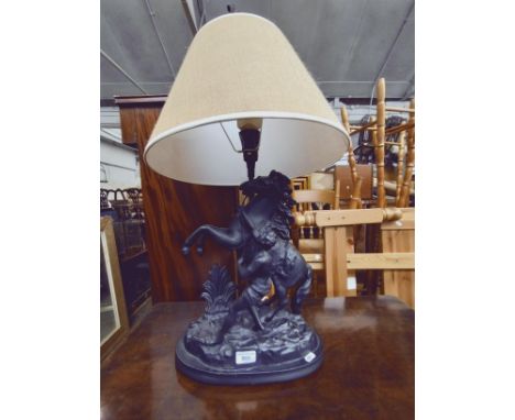 A figural table lamp modelled as a man with horse. 