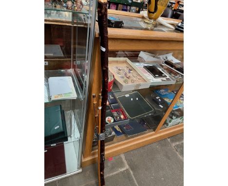 A vintage Rabone yard stick, a bamboo swager stick and a knotted walking staff. 