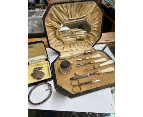 A vintage manicure set in original case, a small bottle with hallmarked silver lid, and a hallmarked silver bracelet and neck