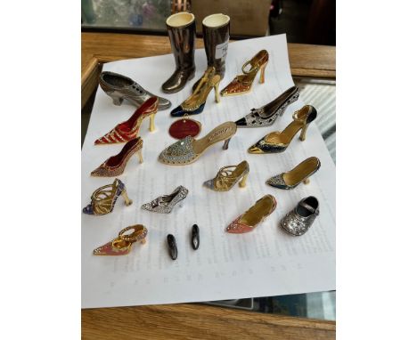 A collection of metal shoes, mainly brass decorated with enamel  etc,  including Juju Palais Royal etc 