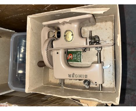 A vintage child's sewing machine, bits for sewing machine and some haberdashery items. 