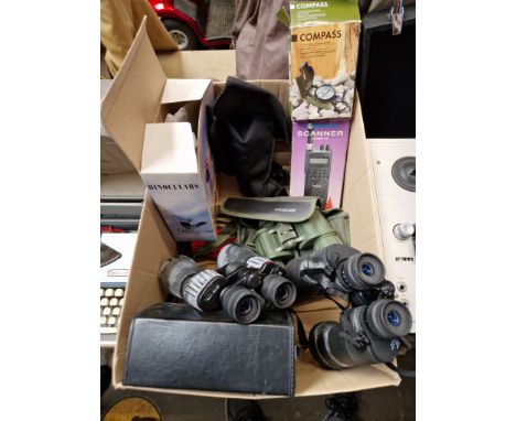 A box of binoculars, compass, scanner mini tripod.