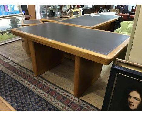 A 1940s oak writing table by Abbess, the rectangular top with tooled leather inset, raised on moulded trestle supports (76 x 