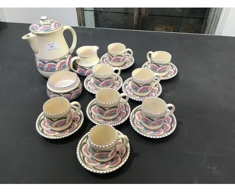 A Honiton coffee set consisting of coffee pot, jug, cream and eight cups and saucers
