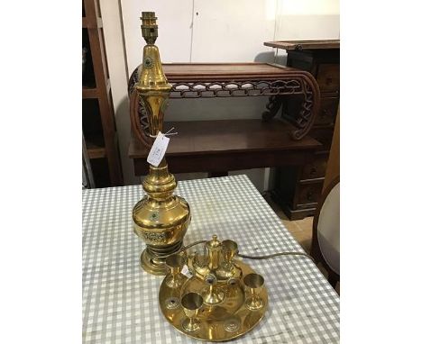 An Eastern brass table lamp with applied castings and roundels, with inset polished stones, together with a brass rosewater b
