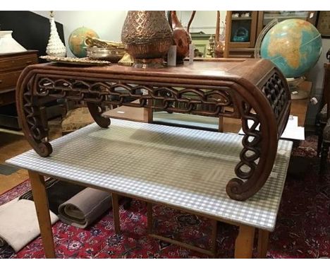 A Chinese burr-wood low table, the recessed panel top above a pierced frieze and inward scrolling legs (38 x 101 x 46cm)