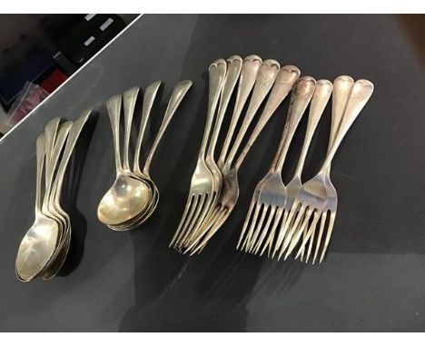 A group of Old English pattern hallmarked silver flatware, engraved tops, including five table spoons, four soup spoons, five