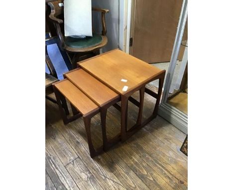 A set of three 1960s graduated teak tables, each with impressed stamp 73 on the underside (largest table: 49 x 53 x 44cm)