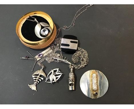 A mixed lot of white metal and silver jewellery including a circular white metal brooch/pendant, a white metal whistle on cha