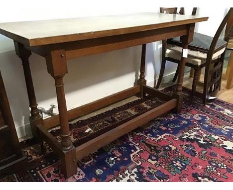 An Arts &amp; Crafts oak side table in the manner of Edwin Lutyens, of refectory table form, the solid two plank top raised o