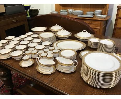 A Royal Grafton Regal pattern white bone china dinner service with gilt edged decoration, consisting of tureens, ashets, dinn