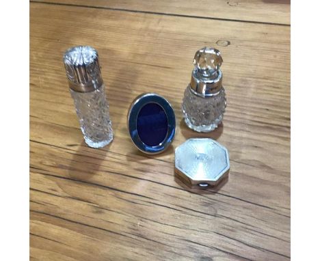 A mixed lot of silver including a silver topped perfume bottle and another, a silver miniature oval frame, an octagonal engin