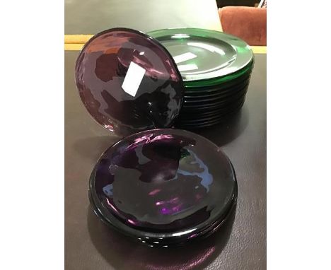 Thirteen green glass plates together with six amethyst coloured glass plates