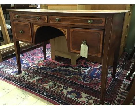 A 19th century mahogany and satinwood-banded dressing table, the rectangular top above four drawers arranged around a central