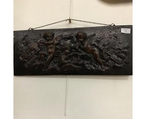 A relief cast moulded plaster panel of Putti playing Instruments (54cm x 21cm)