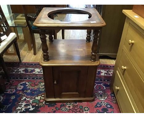 A Victorian mahogany basin stand, the raised recess above a panel door, raised on a plinth base (81 x 52 x 46cm)