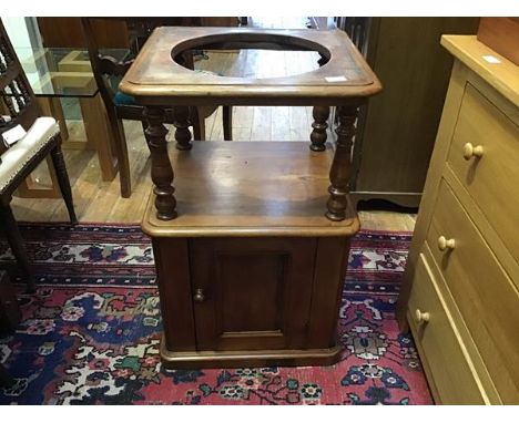 A Victorian mahogany basin stand, the raised recess above a panel door, raised on a plinth base (81 x 52 x 46cm)