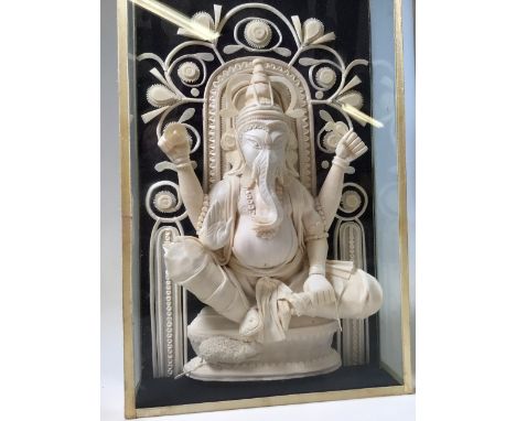 A carved Ganesha, elephant headed Hindu god. A carved sculpture in light wood in box frame. W:20cm x D:6cm x H:33cm