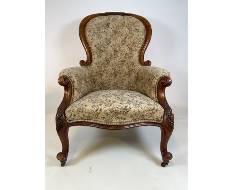 A Victorian mahogany button backed chair with floral upholstery finish. On metal castors. Seat height H:40cm