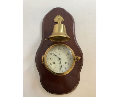 A Howard Miller 11 jewels brass clock and brass stricking bell on mahogany mount. Model No 613-463. W:25cm x H:48cm