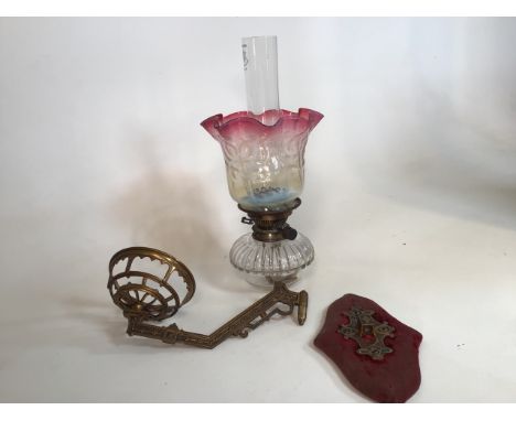 A wall mounted single Duplex brand oil lamp with original glass shade and column. Brass wall fitting H:49cm approx 
