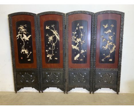 An early 20th century double sided Chinese four fold screen ornately carved oak panels with ivory and mother of pearl carved 