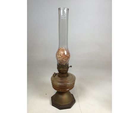 An oil lamp on wooden base H:22.5cm 
