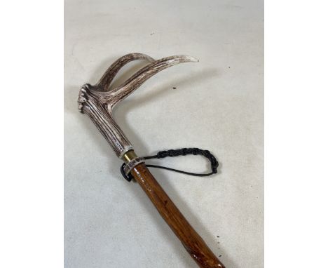 A walking stick - hazel with honeysuckle twist with a polished red deer antler handle with brass collar and ferruleH:132cm Le