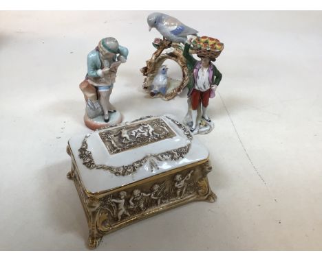 A Capodimonte footed lidded ceramic box decorated with children together with three decorative figurines W:17cm x D:14cm x H: