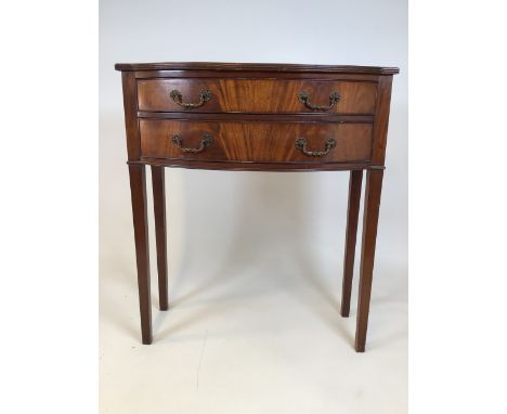 An early 20th century bow fronted console table with two drawers with brass handles on square tapered legs. W:77cm x D:37cm x