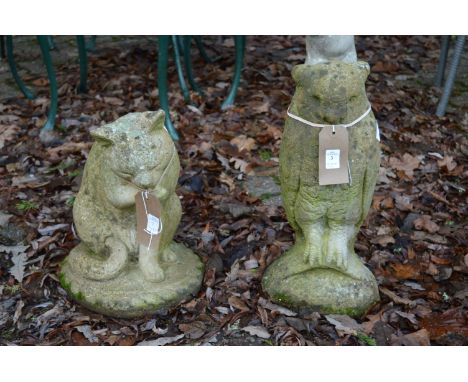 Two reconstituted stone garden ornaments, one modelled as a owl the other a cat licking its paw.