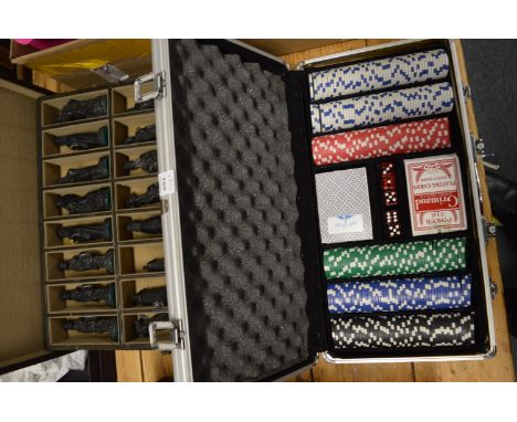 Poker set and a case containing chess pieces.