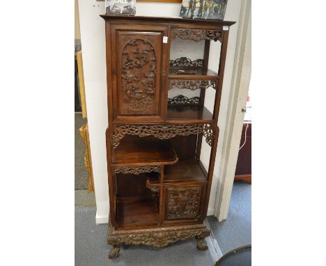 A late 19th century carved hardwood display cabinet with two decoratively carved panel doors, a calligraphy side panel, vario