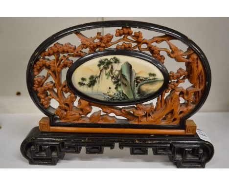 A Chinese carved wood table screen.