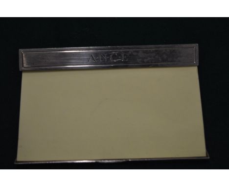 An Asprey &amp; Garrard silver post-it note holder.