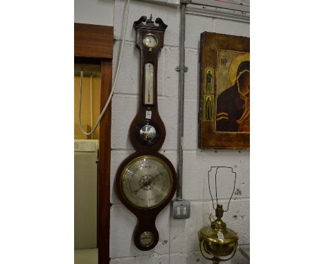 A mahogany cased wheel barometer/thermometer.