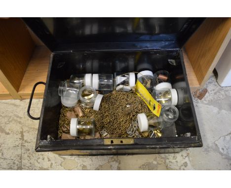 A small tin trunk containing picture hanging equipment.