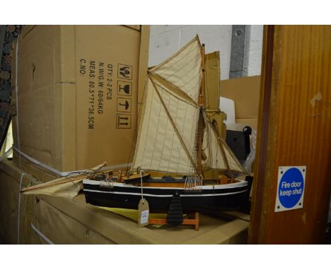 A model sailing ship and two garden ornaments.