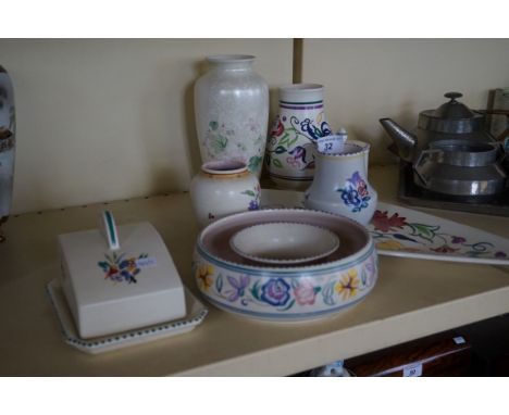 Eight pieces of Poole Pottery each having floral decoration to include a spear, cheese dish and cover etc