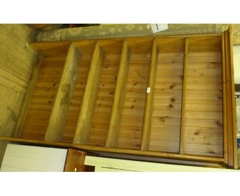 A rustic pine shelf unit, having five fixed shelves. 