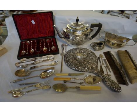 A mixed lot of assorted hallmarked silver and silver-plate to include teapot, cream jug, part of a dressing table set, flatwa