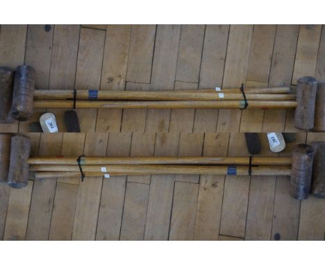 A set of vintage golf clubs, and a set of croquet hammer.