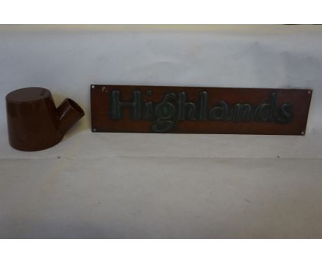 An unusual treacle glazed inkwell together with an Arts & Crafts door plate entitled 'Highlands' produced by Hugh Wallace of 